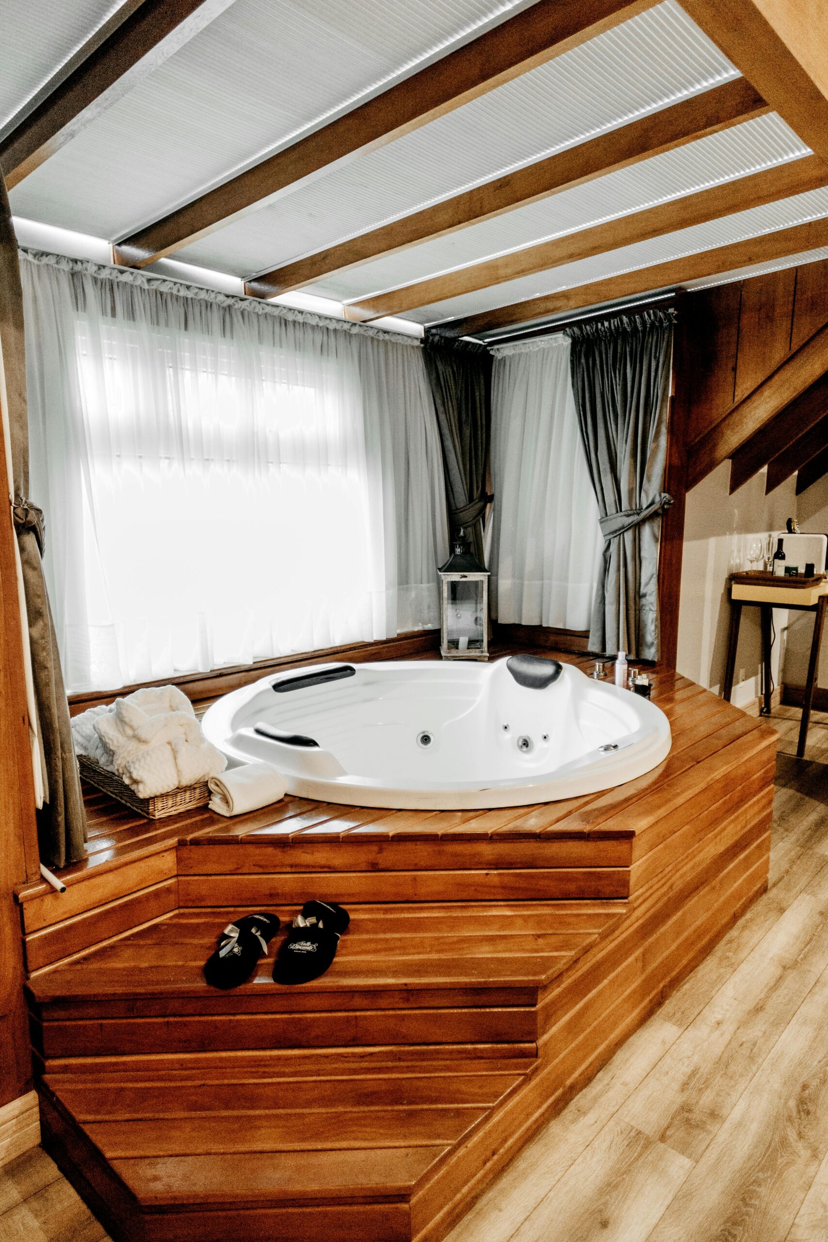 pexels photo 3101547 3101547 Elegant indoor spa featuring a modern wooden bathtub with luxurious amenities, perfect for relaxation.